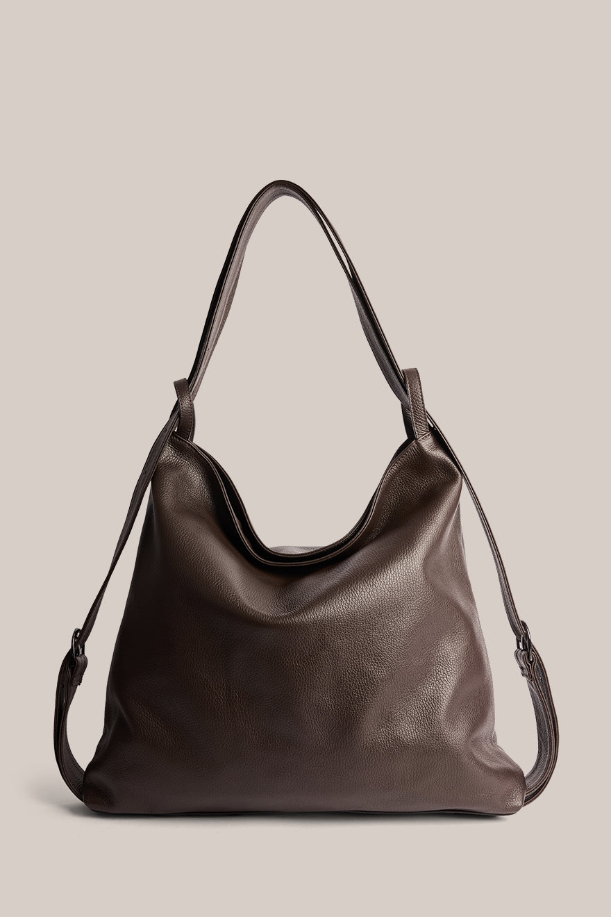 Brown leather handbag on a beige background
