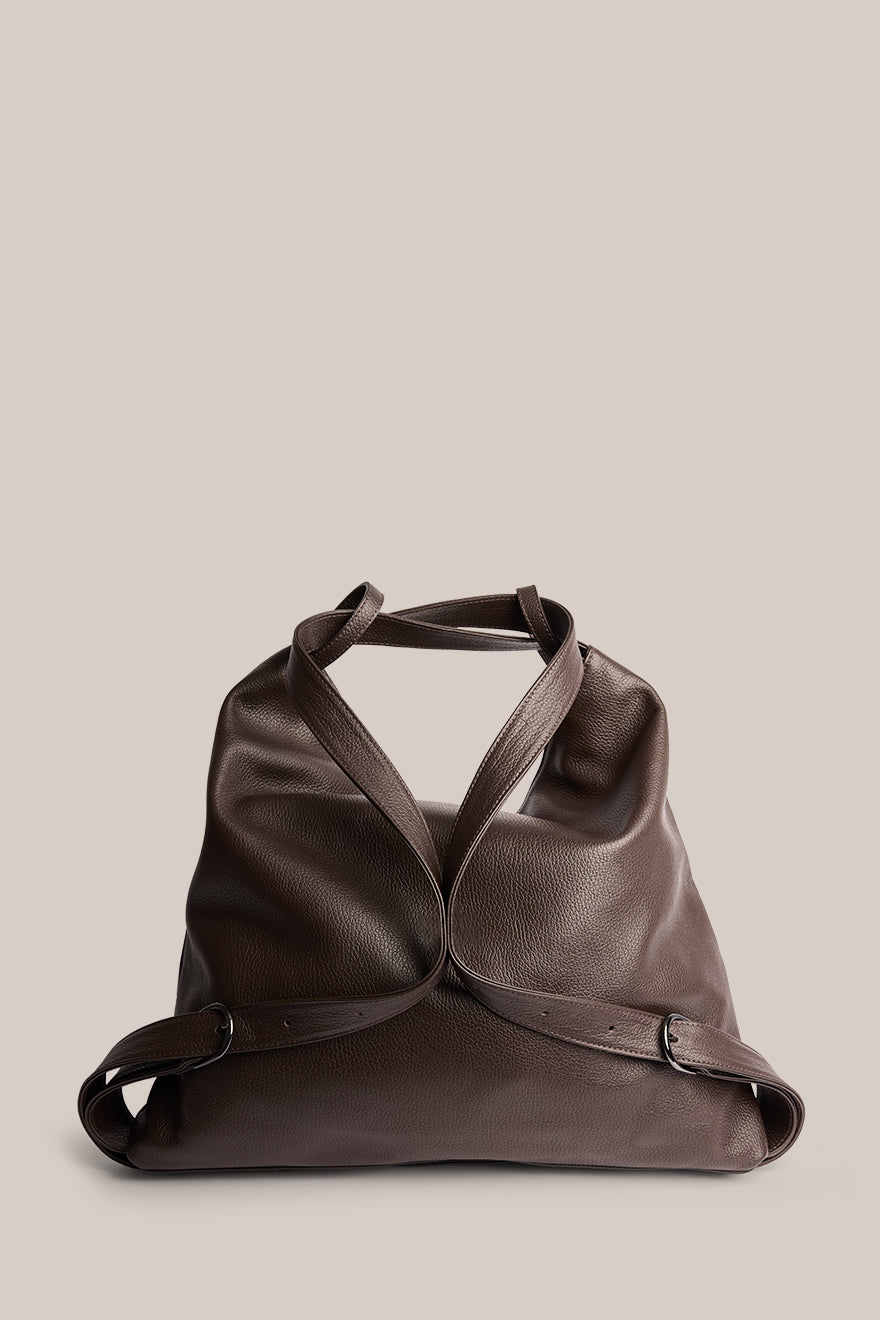 Brown leather bag on a beige background